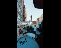 Marching band performing on sidewalk