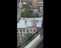 Kid learns how to ride bicycle rooftop 