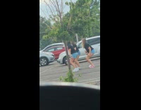 Four women same outfit parking lot dance