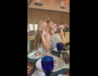 Two girls pose with pizza string lights