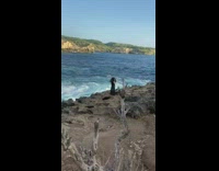 Girl with feather head dress ocean cliff