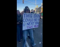 Woman holds sign take number for marathon