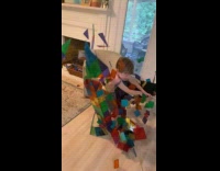 Toddler run towards toy tower slow motion