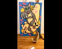 Two cats fight in front of painting