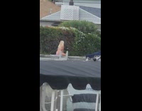 Blonde woman bikini sit on ledge docks