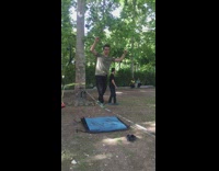 Guy does a backflip while walking a slackline and lands on his crotch