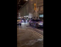 Multiple cars covered with Christmas lights street night