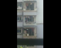 Little boy bangs pots apartment window 