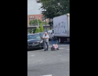 Elderly woman dances while crossing street 