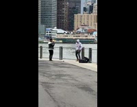 Guy grey hoodie rap pier woman films