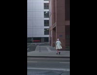 Person pink cap cardigan walk pose street