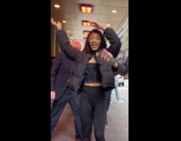 Woman dances with doorman Bernie Sanders behind