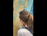 Woman look at dog then hide behind wall