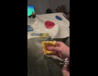 Person Squeezes Synthetic Inflatable Cube Cheese Toy