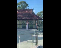 Woman swings her bag to the camera at the balcony