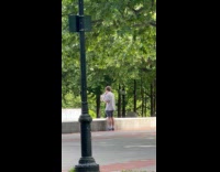 Guy kisses dog while doing bicep curls