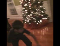 Slowmo Ripstick Kid On Wooden Floor Falls in Front of Christmas Tree