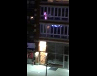 Guy blasts music at night sidewalk apartment 