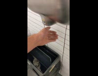 Trash can lid spins because of hand dryer