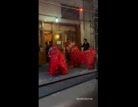 Two red lion dance outside chinese cafe