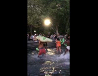 Group of people fight in inflatable pool at park with floaties part 2 