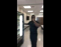 Guy pushes vending machine to make drinks fall 