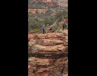 Guy holds hands inflatable dinosaur costume mountain 