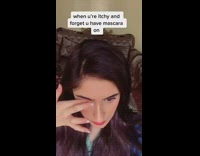 Lady rubs eye while wearing mascara 