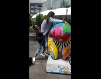 Girl tries to climb art sculpture falls 