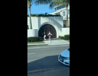 Two women dancing for tiktok on sidewalk