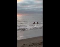 Woman topless photoshoot on the beach shore