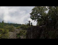 Black wetsuit guy four backflips off cliff 