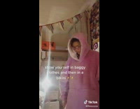 Girl wears bikini over baggy pink sweater