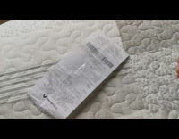 Girl sprays hand sanitizer on receipt paper 