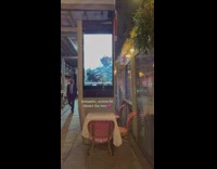 Dinner table along street at night in NYC 