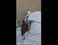 Guy shows black white striped socks underneath pants