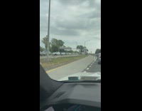 Cars stuck in traffic by mobil gas station 