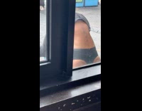 Collab WINY - Man try headstand beside restaurant glass window