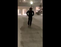 Guy slides down icy sidewalk snow 