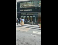 Man in hospital gown walks on street