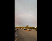 Woman amused to see a clear rainbow