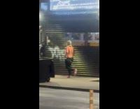 Shirtless man jogging across the street