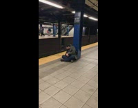 Guy subway station leans over to puke 