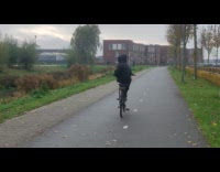 Guy rides bike without holding or pedaling