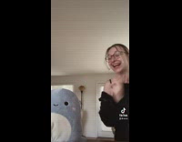 Girl slaps brown squish mallow and it lands on top of lamp