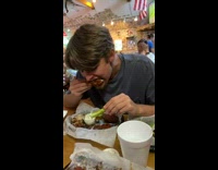 Guy uses celery scoops ranch onto chicken wing 