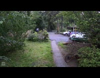 Security cam of guy riding bike falling over wooden plank