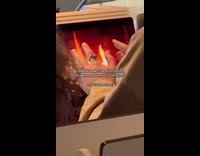 Guy puts hand near video of fireplace