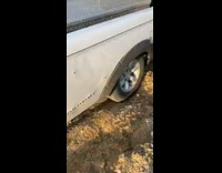 White truck stuck in dirt mud 