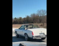 Guy drives with roof off at highway